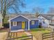 Cozy blue bungalow with a well-kept yard and a bright yellow front door at 917 Garibaldi Sw St, Atlanta, GA 30310