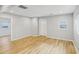 Spacious living room with laminate floors, white door, and view into hallway at 917 Garibaldi Sw St, Atlanta, GA 30310