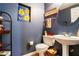 Stylish powder room features blue walls, decorative art, and a pedestal sink at 2160 Berryhill Se Cir, Smyrna, GA 30082