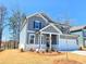 Charming two-story home featuring gray siding, a white brick foundation and manicured landscaping at 2369 Brown Dove Way (Lot 3), Grayson, GA 30017