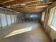 Large unfinished basement with natural light from windows, framed-out walls and concrete floor at 2515 Hogan Rd, East Point, GA 30344
