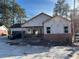 Exterior view of house with brick and siding construction under clear skies at 2515 Hogan Rd, East Point, GA 30344