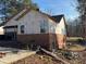 Exterior view of house with brick and siding construction under clear skies at 2515 Hogan Rd, East Point, GA 30344