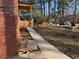 Exterior view of house under construction and long, cracked sidewalk at 2515 Hogan Rd, East Point, GA 30344