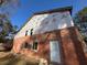 Side view of house with brick and siding construction under clear blue skies at 2515 Hogan Rd, East Point, GA 30344