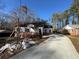 Exterior view of house with brick and siding construction, long driveway with clear skies at 2515 Hogan Rd, East Point, GA 30344