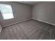 A cozy bedroom offers soft carpeting, neutral paint, and a light-filled window at 2921 8Th St, East Point, GA 30344