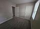 Bedroom featuring carpet flooring, neutral paint, window, and multiple entry doors at 2921 8Th St, East Point, GA 30344