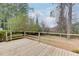 Inviting wooden back deck surrounded by lush greenery, ideal for outdoor relaxation and entertainment at 2874 Arrow Creek Dr, Atlanta, GA 30341