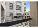 Balcony view of the commercial area below featuring black metal guardrails at 587 Virginia Ne Ave # 315, Atlanta, GA 30306