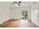 Large bedroom with hard wood floors, ceiling fan, and sliding glass door at 587 Virginia Ne Ave # 315, Atlanta, GA 30306