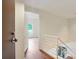 Bright entryway with hardwood floors and white staircase railing leading to a loft area at 587 Virginia Ne Ave # 315, Atlanta, GA 30306