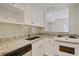 Well-lit kitchen featuring white cabinets, granite countertops, and stainless steel appliances at 587 Virginia Ne Ave # 315, Atlanta, GA 30306