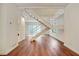 Open-concept living room with wood floors and staircase, filled with natural light at 587 Virginia Ne Ave # 315, Atlanta, GA 30306