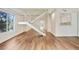 Spacious living room featuring wood floors, large window, and staircase at 587 Virginia Ne Ave # 315, Atlanta, GA 30306