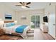 Staged main bedroom with hard wood floors, ceiling fan, and sliding glass door at 587 Virginia Ne Ave # 315, Atlanta, GA 30306