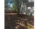 A spacious backyard with a wooden fence and sparse foliage at 12264 Crestwood Ct, Fayetteville, GA 30215