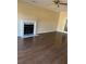 Spacious living room with hardwood floors and fireplace with white mantle at 12264 Crestwood Ct, Fayetteville, GA 30215