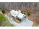 Aerial view of the house showing the driveway and surrounding mature trees at 550 Oak Ridge Dr, Oxford, GA 30054