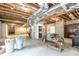 Unfinished basement offering potential for storage or customization, and exposed ceiling beams at 550 Oak Ridge Dr, Oxford, GA 30054