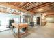 Spacious unfinished basement perfect for a workshop with work tables and exposed ductwork at 550 Oak Ridge Dr, Oxford, GA 30054