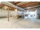Unfinished basement with exposed wood ceiling beams provides ample storage and workspace at 550 Oak Ridge Dr, Oxford, GA 30054