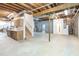 Unfinished basement area featuring exposed ceiling, concrete floor, and staircase access at 550 Oak Ridge Dr, Oxford, GA 30054