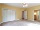 Bedroom featuring large closet, carpeted floor and view into bathroom at 550 Oak Ridge Dr, Oxford, GA 30054