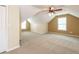 Spacious bonus room featuring neutral carpet, ample natural light, and a ceiling fan at 550 Oak Ridge Dr, Oxford, GA 30054