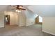 Expansive bonus room with neutral carpet, bright natural light, and a walk-in closet at 550 Oak Ridge Dr, Oxford, GA 30054