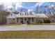 Beautiful brick home with a metal roof, dormer windows, and a large front yard at 550 Oak Ridge Dr, Oxford, GA 30054