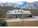 Beautiful brick home with a metal roof, dormer windows, and a large front yard at 550 Oak Ridge Dr, Oxford, GA 30054