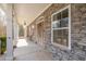 Stone front porch with stone columns and a wooden front door at 550 Oak Ridge Dr, Oxford, GA 30054