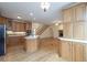 Open concept kitchen with island and stainless steel appliances flows into living space with stairs at 550 Oak Ridge Dr, Oxford, GA 30054