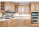Well-equipped kitchen featuring wood cabinets, stainless steel appliances, and tile backsplash at 550 Oak Ridge Dr, Oxford, GA 30054