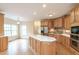 Bright kitchen featuring wood cabinets, stainless steel appliances, a large island, and an open layout at 550 Oak Ridge Dr, Oxford, GA 30054