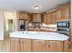 Kitchen island with stainless steel appliances and tile backsplash at 550 Oak Ridge Dr, Oxford, GA 30054