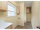 Compact laundry room with cabinets, linoleum flooring, and a single window for ventilation at 550 Oak Ridge Dr, Oxford, GA 30054