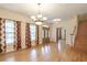 Open living room with hardwood floors, a chandelier, and lots of natural light at 550 Oak Ridge Dr, Oxford, GA 30054