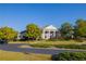 A view of the community's Heritage Club with manicured landscaping and mature trees at 866 Lakemont Dr, Canton, GA 30114