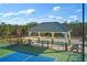 Community tennis courts with shaded gazebo and benches surrounded by lush green trees at 866 Lakemont Dr, Canton, GA 30114
