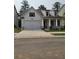 Charming home boasts a two-car garage, inviting porch, and neutral color scheme at 866 Lakemont Dr, Canton, GA 30114