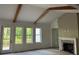 Bright living room featuring vaulted ceilings, exposed wood beams, a fireplace and many windows at 866 Lakemont Dr, Canton, GA 30114
