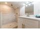 Updated bathroom showcasing a tiled shower with pebble accents and a modern vanity with white countertop at 1472 North Nw Ave, Atlanta, GA 30318