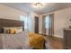 Comfortable bedroom featuring a large bed with decorative pillows, hardwood floors, and ample natural light at 1472 North Nw Ave, Atlanta, GA 30318