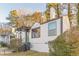 Charming home with white siding, black trim, and a welcoming front entrance, surrounded by lush greenery at 1472 North Nw Ave, Atlanta, GA 30318