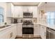 Bright kitchen with stainless steel appliances, white cabinetry, and modern fixtures at 1472 North Nw Ave, Atlanta, GA 30318