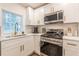 Well-lit kitchen featuring stainless steel appliances and white cabinets at 1472 North Nw Ave, Atlanta, GA 30318