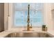 Modern kitchen sink featuring a stylish gold faucet and bright natural light from the window at 1472 North Nw Ave, Atlanta, GA 30318