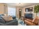 Cozy living room with blue sofa, wood floors, and a large window for natural light at 1472 North Nw Ave, Atlanta, GA 30318